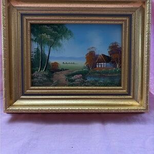 Vin rural landscape framed art in gold frame.